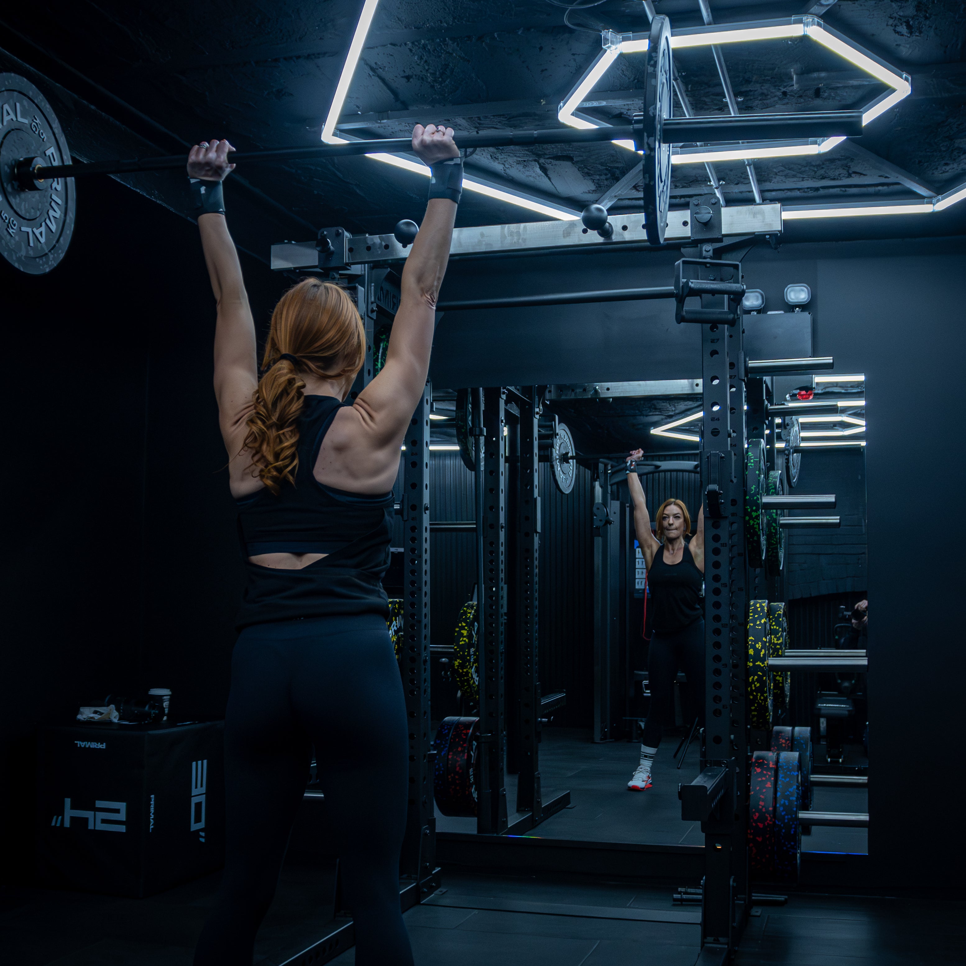 Lady performing a shoulder press in a private My Fit Pod gym in Berkhamsted